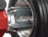 Coats CHD 6330 four-jaw chuck gripping a truck wheel rim close-up