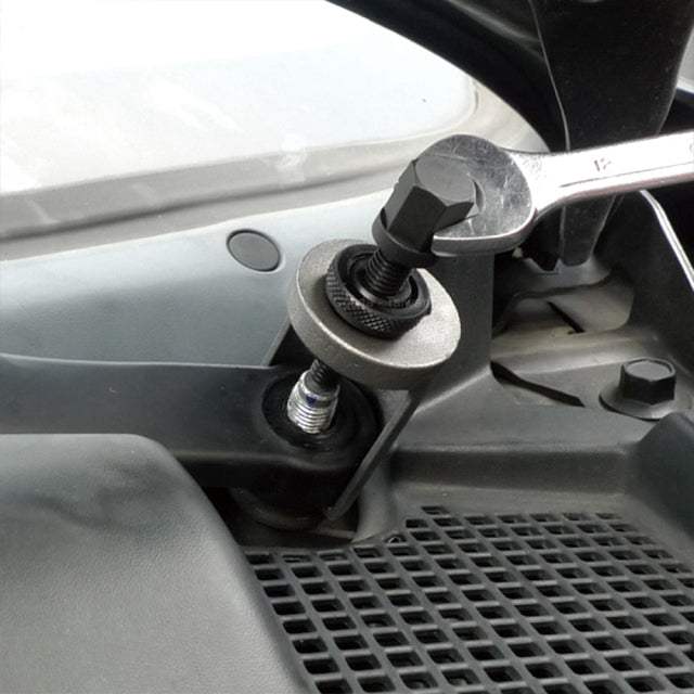 Wiper arm cup-type extractor being used with a wrench on a vehicle