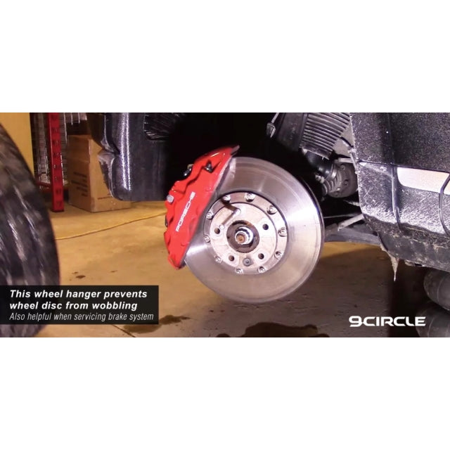 9Circle 96054 Wheel Hanger in use on Porsche - prevents wheel disc from wobbling during tire service
