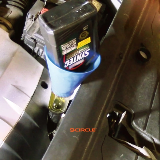 9 Circle blue oil funnel in use adding motor oil to engine via filler neck