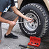 Person kneeling and using Access Tools Easy Off Twist Socket with breaker bar on vehicle tire
