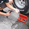 Person using Access Tools Easy Off socket and breaker bar to remove lug nut from tire