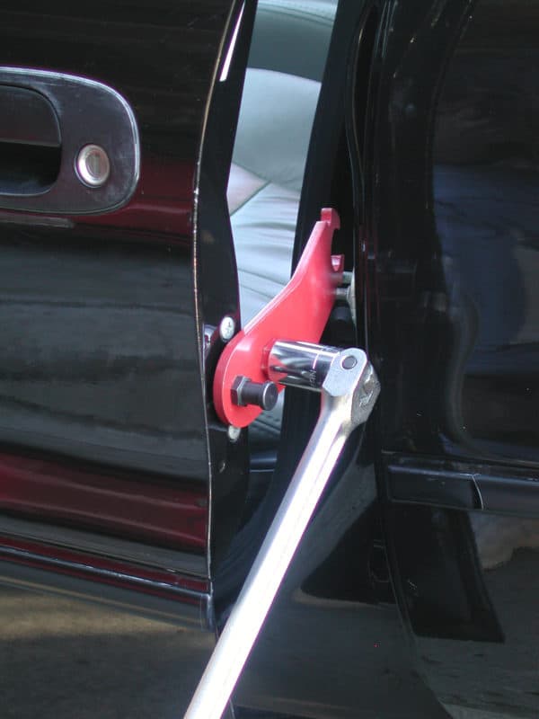 Milton Industries 21845 E-Z Store Door Alignment Bar in use on car door hinge with breaker bar