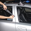 Access Tools FACOS - technician using long reach tool to unlock car door