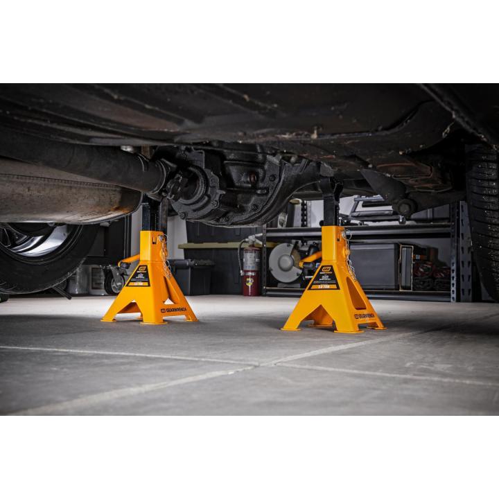 Gearwrench GWJS3T 3-Ton Jack Stands in use supporting a vehicle undercarriage in a garage