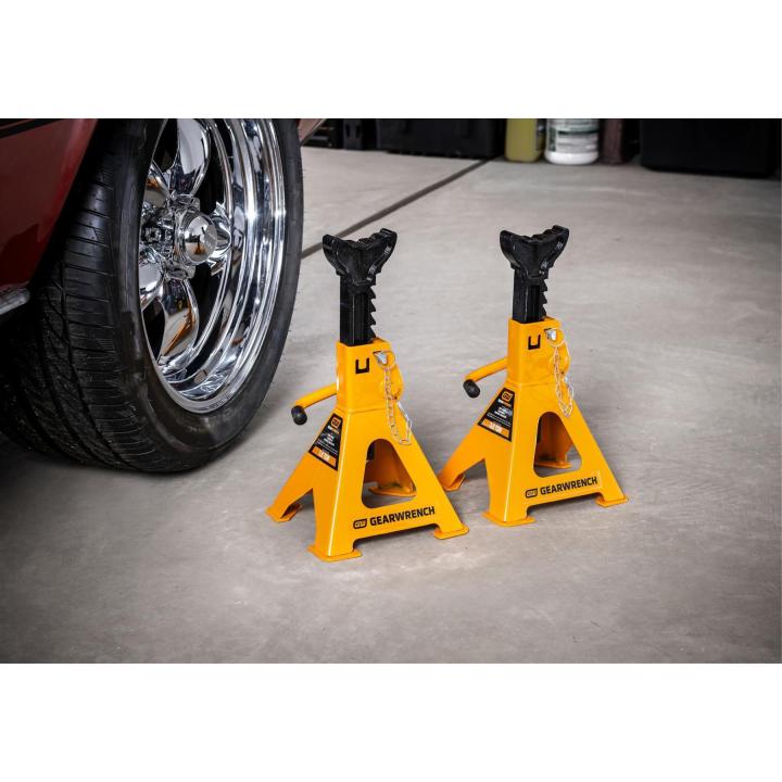 Gearwrench GWJS3T 3-Ton Jack Stands positioned next to a classic car tire in a garage