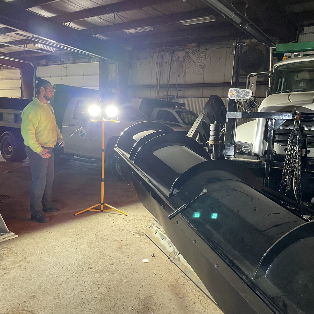 Alert Stamping LF240ST ProLite Twin LED Tripod Flood Light illuminating garage work area at night