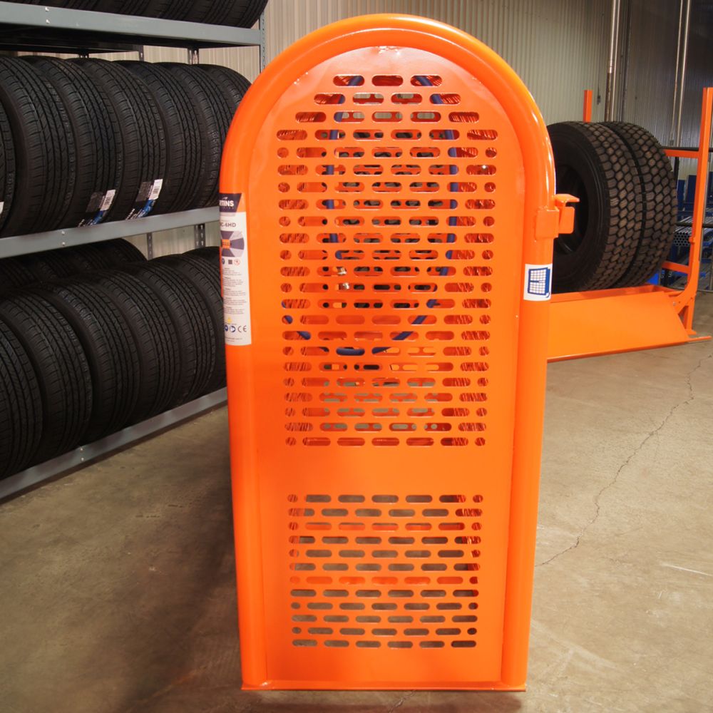 Martins Industries MIC-6HD Tire Inflation Safety Cage side view displayed in a tire shop environment