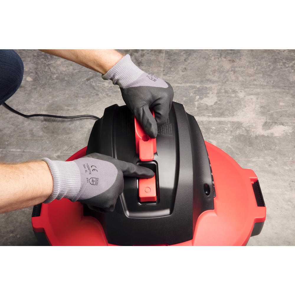 Close-up of Ridgid RT0600 motor head latch mechanism being operated with gloved hands