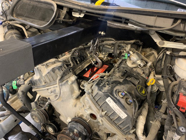 Steck STC50133 ENGINEOUT Engine Lift Plate shown in Ford vehicle engine bay ready for use