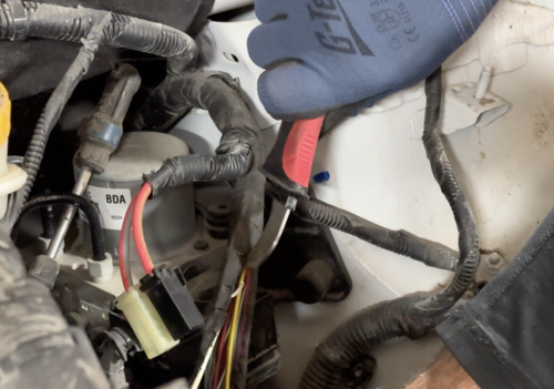 Lisle 11410 Cable Stripping Knife in use slitting wire loom sheath in automotive engine bay