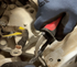 Lisle 11410 Cable Stripping Knife being used in tight automotive engine compartment