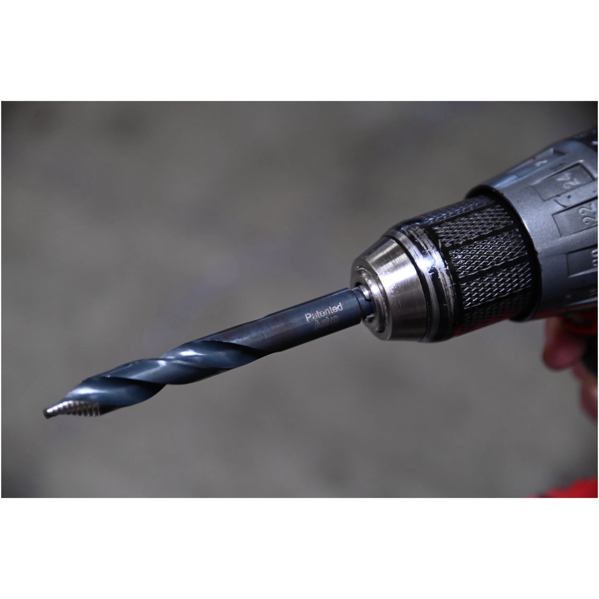 Astro Pneumatic TS21 TurboStep HSS drill bit in drill chuck showing spiral fluted stepped-tip design