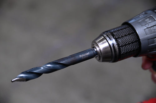 Astro Pneumatic TS21 TurboStep HSS patented drill bit loaded in drill chuck, in-use lifestyle photo