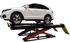White SUV elevated on Coats 14K scissor alignment lift with red scissor mechanism