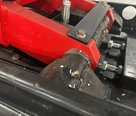 Close-up of zerk grease fittings on the pivot point of the Coats 14K scissor lift