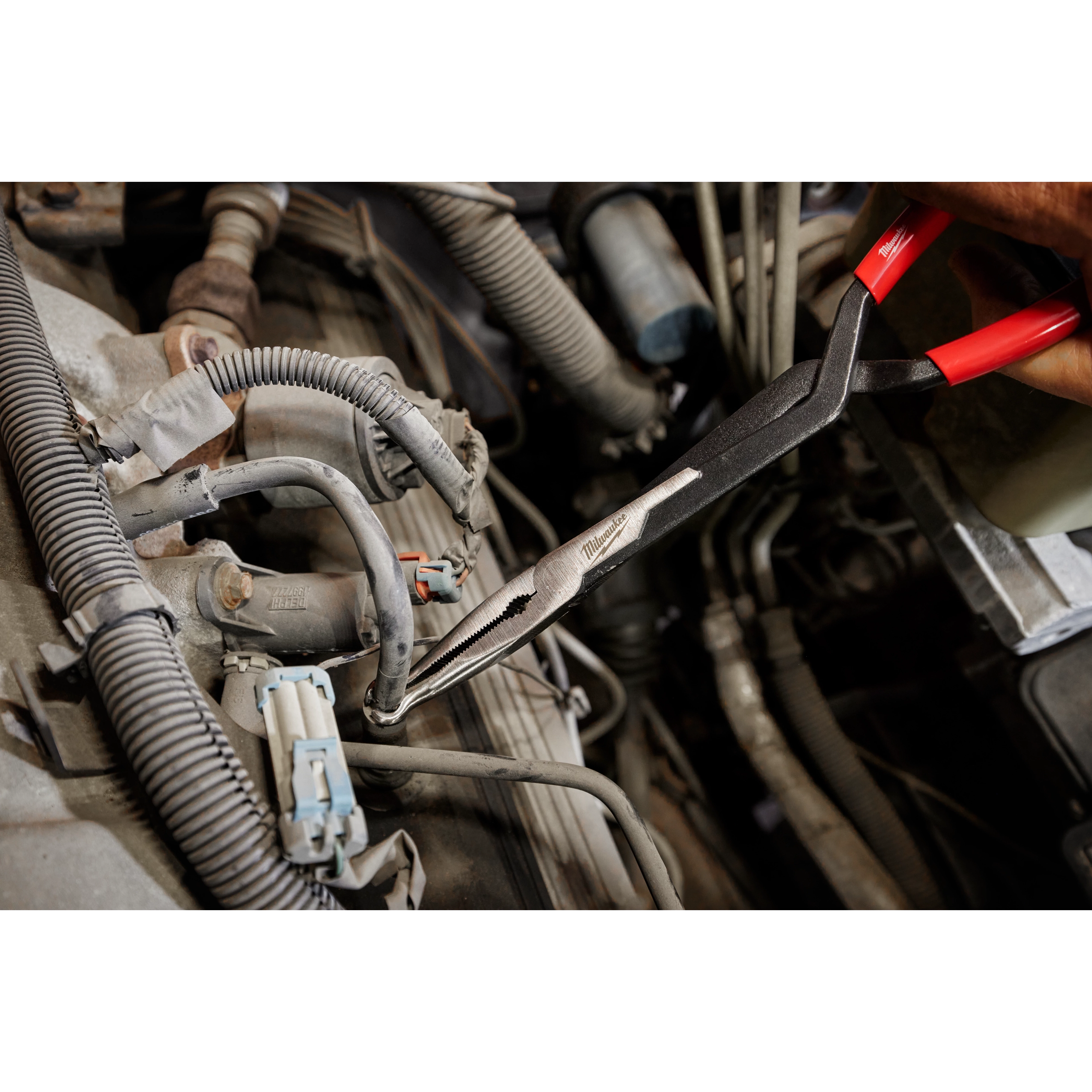 Milwaukee 48-22-6563 Long Reach Hose Grip Pliers reaching into a tight engine bay