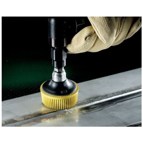 3M 7525 Scotch-Brite Roloc Bristle Disc in use on metal surface with drill