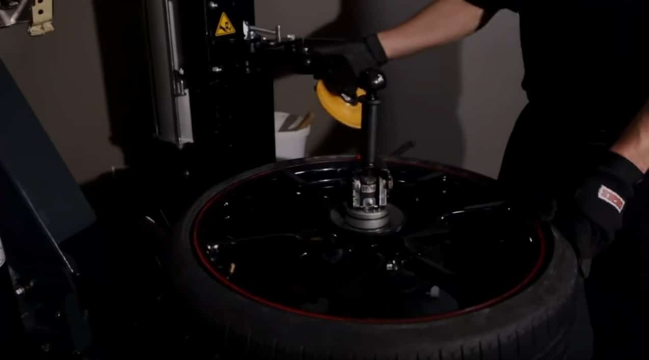 Coats APS 3000 roller disc bead loosener in operation on alloy wheel