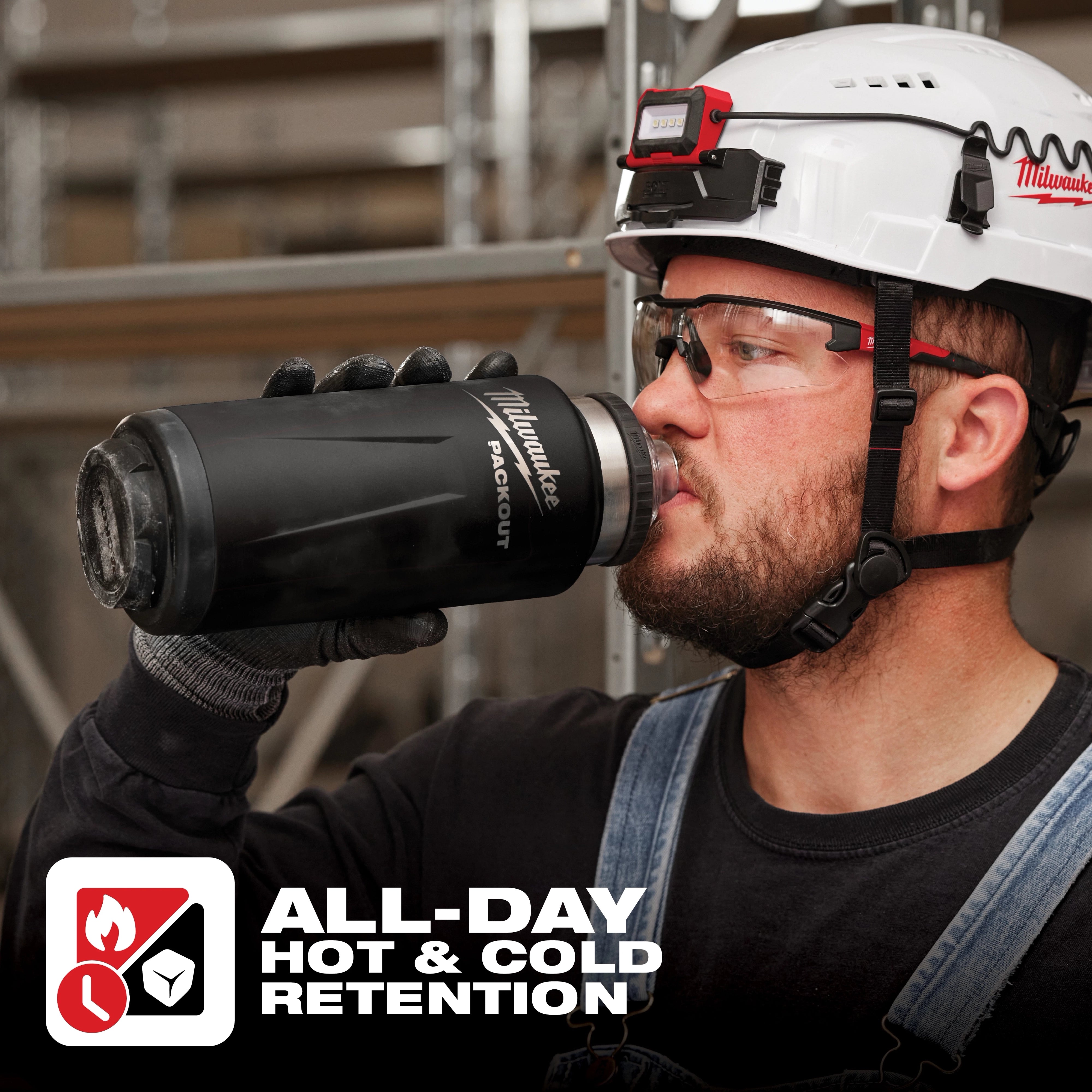 Worker on jobsite drinking from Milwaukee PACKOUT 36oz Black Insulated Bottle - All-Day Hot and Cold Retention