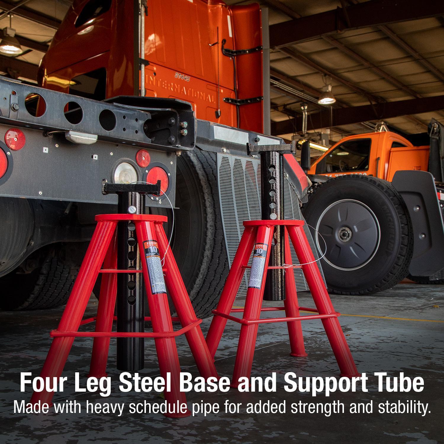 Sunex Tools 1310 Jack Stands pair positioned under semi-truck in fleet garage, four leg steel base and support tube