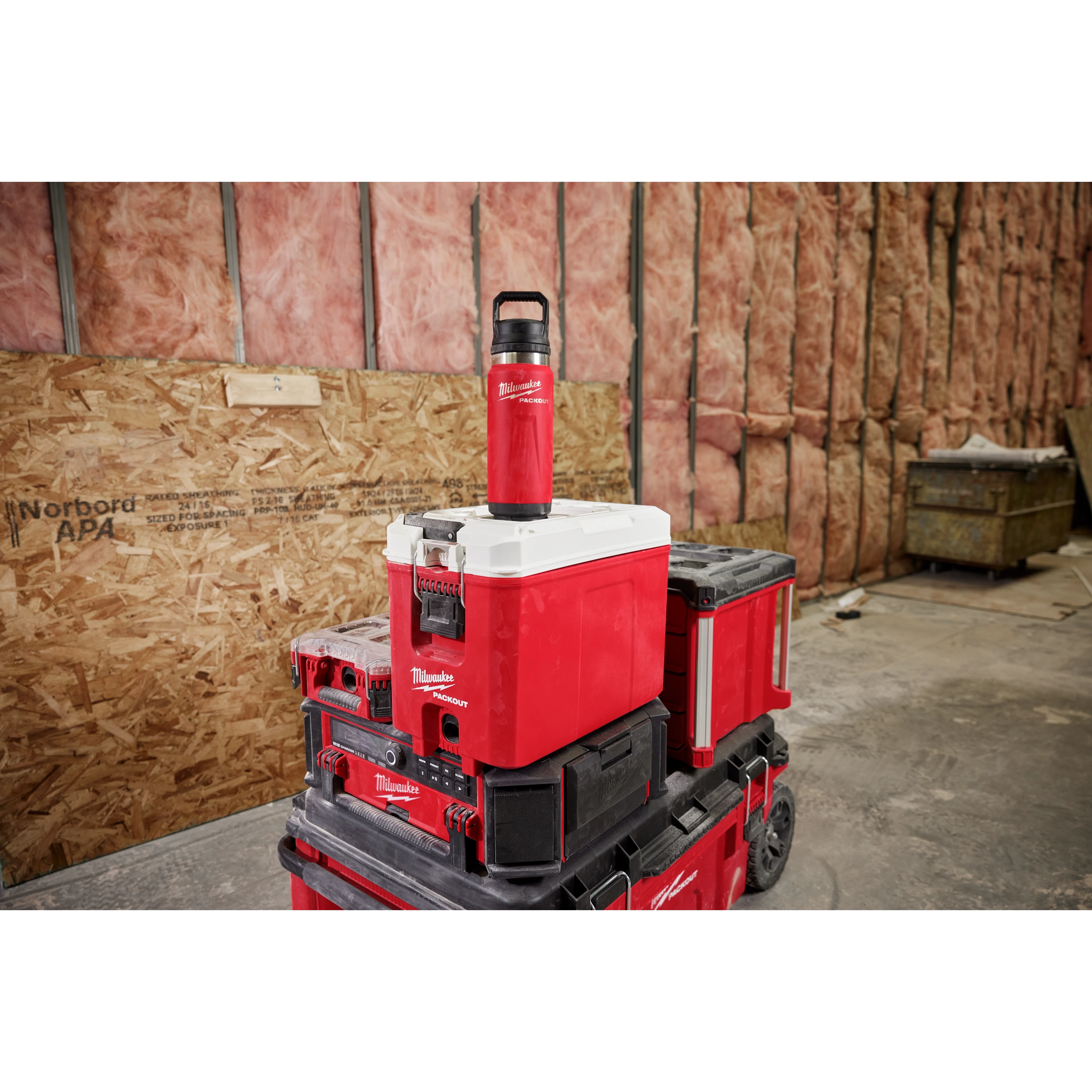 Milwaukee PACKOUT 24oz Insulated Bottle mounted on PACKOUT modular storage system on jobsite