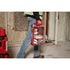 Worker carrying Milwaukee Tool PACKOUT First Aid Kit Type II on jobsite