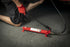 Sunex Tools 4910B hydraulic hand pump with hose being operated on garage floor