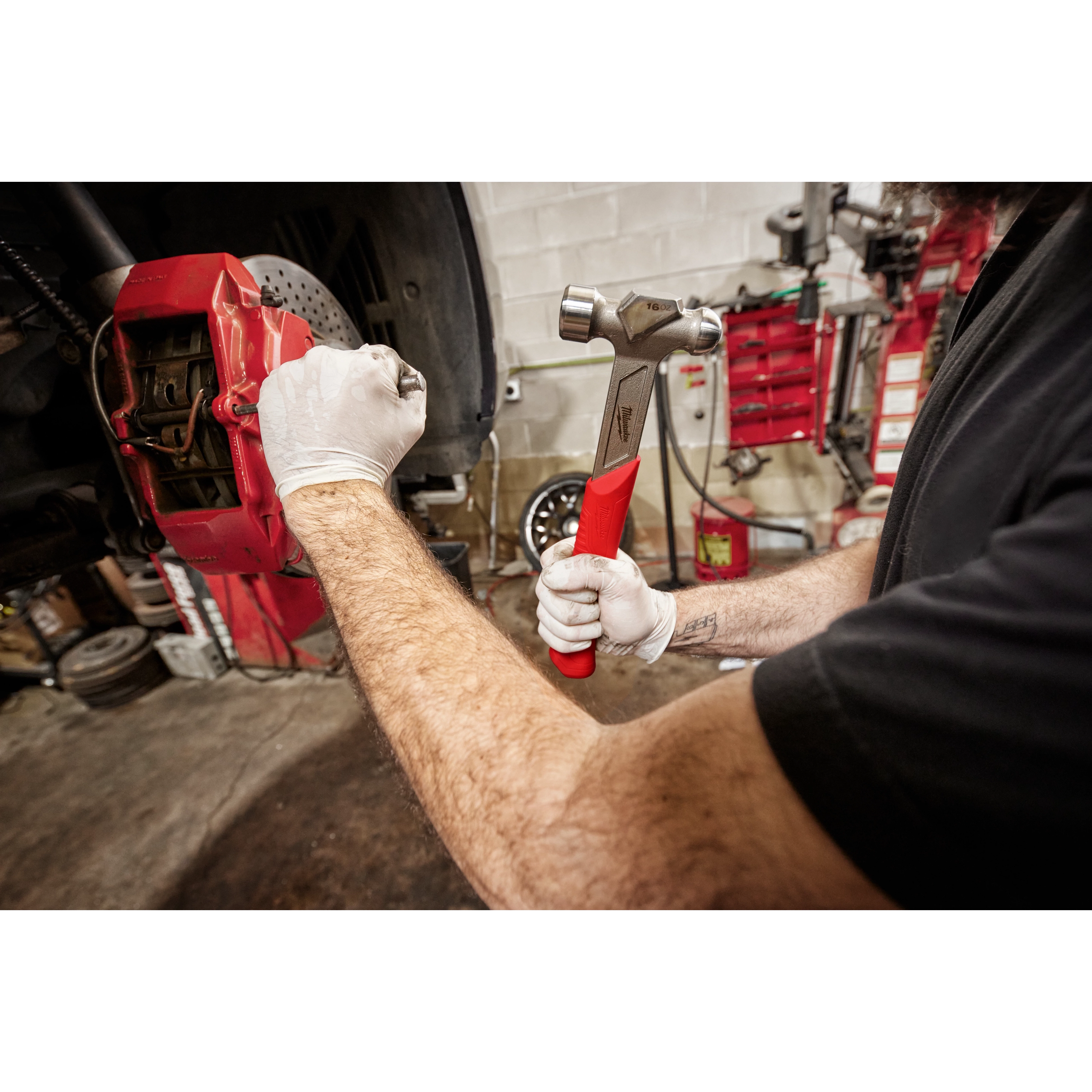 Milwaukee Tool 48-22-9130 16oz Steel Ball Peen Hammer mechanic using hammer on brake caliper in auto shop