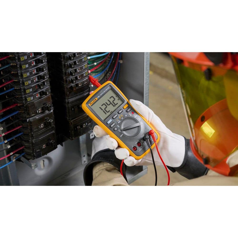 Electrician using Fluke 17B+ Digital Multimeter with gloves at electrical panel