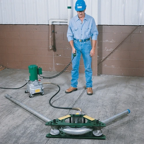 Worker operating Greenlee 880E975 Hydraulic Bender with 975 Electric Pump in warehouse