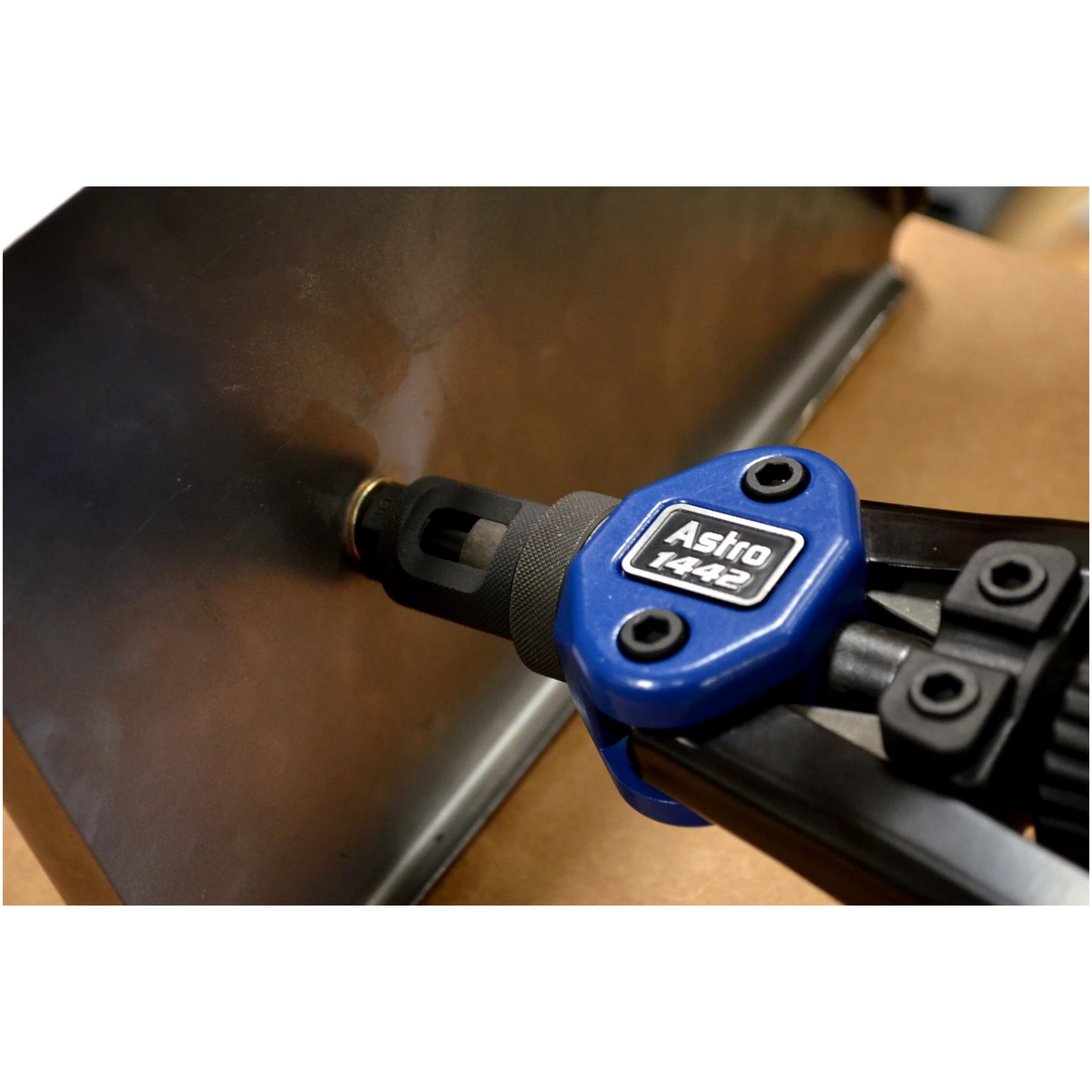 Close-up of Astro Pneumatic 1442 toolless quick-change head setting a rivet nut into a metal sheet