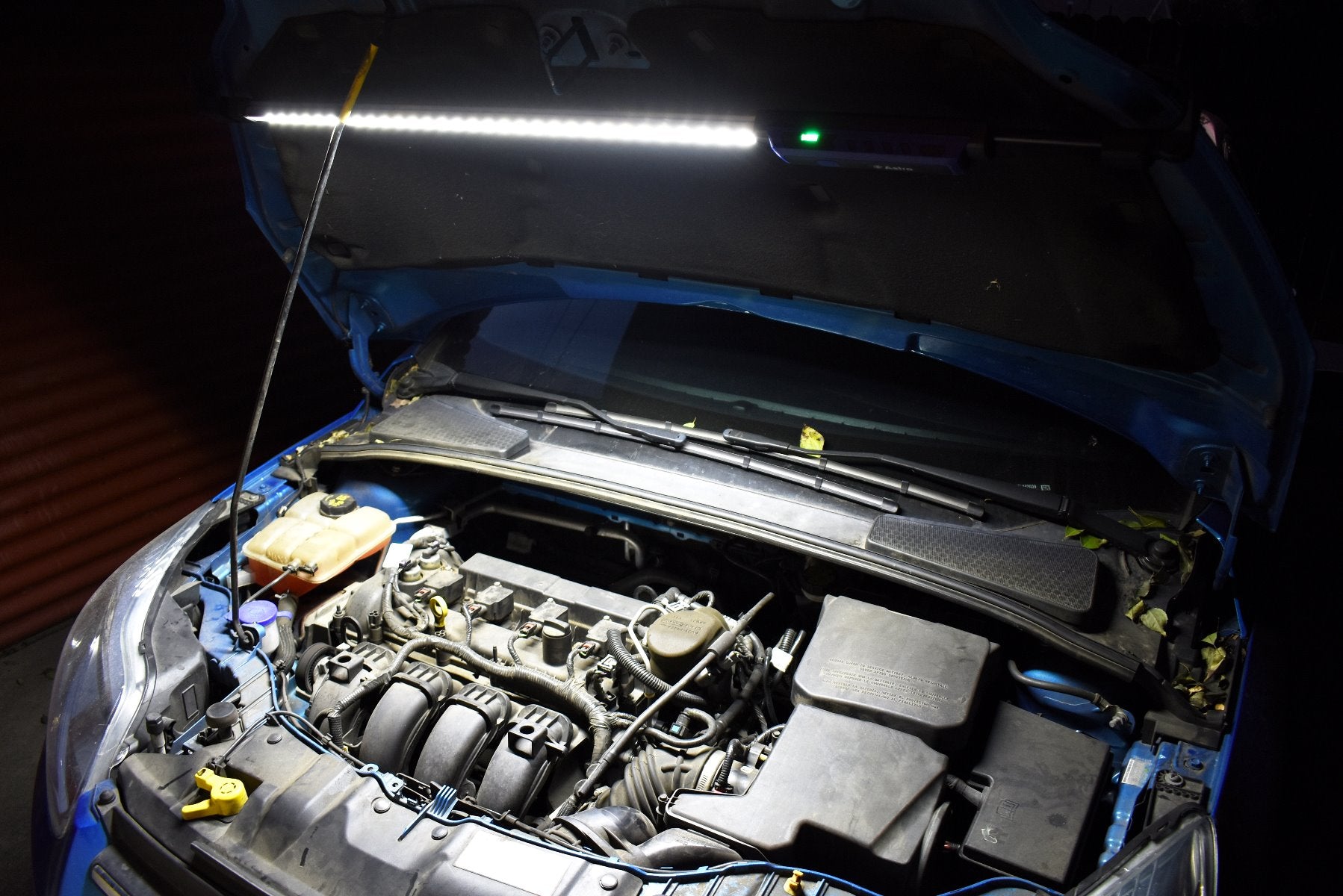Astro Pneumatic 151SL underhood light in use illuminating engine bay under open car hood at night