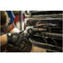 Close-up of Astro Pneumatic 3037 Air Belt Sander in use on vehicle grille