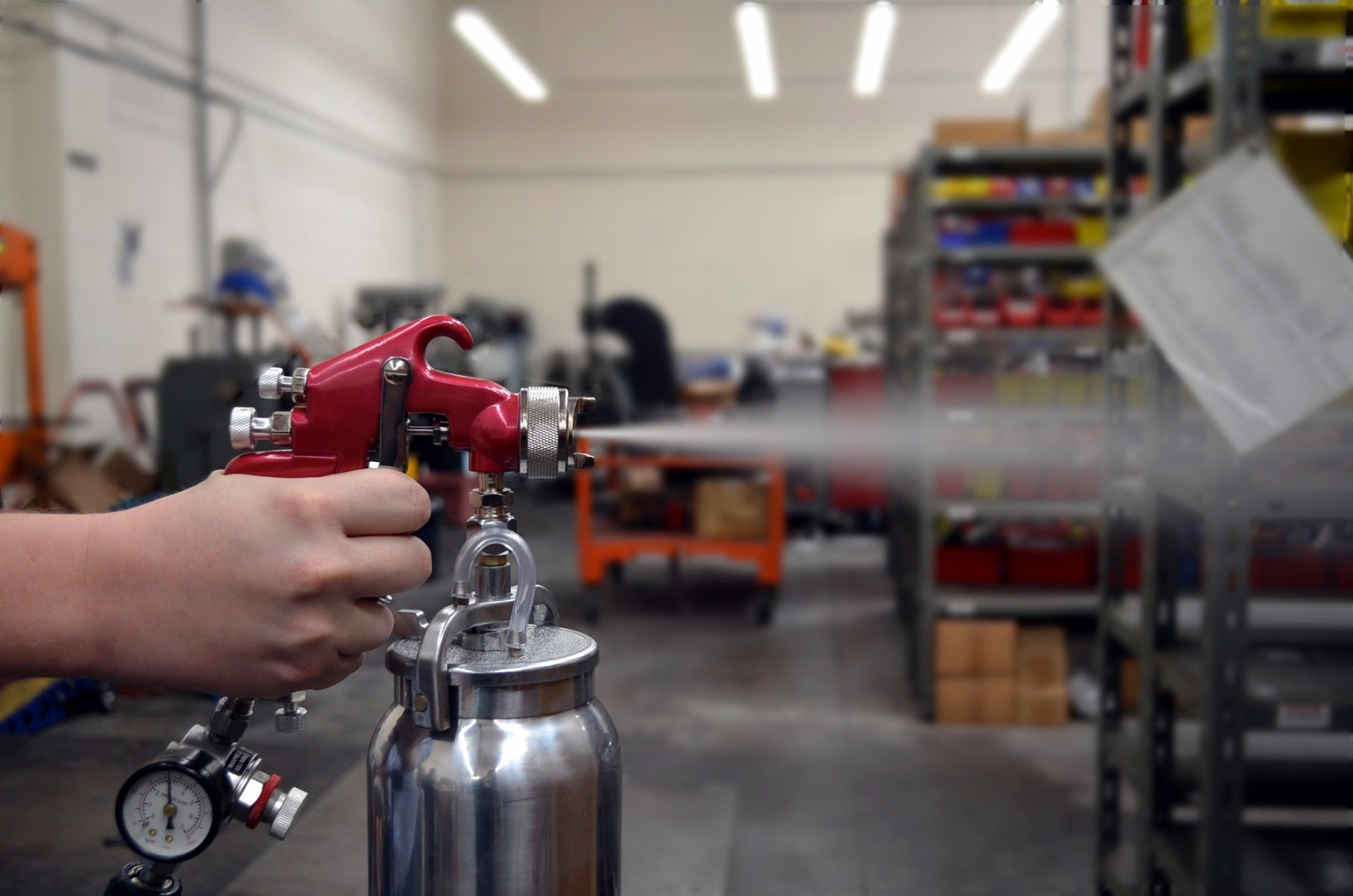 Astro Pneumatic 4008 Red Handle Spray Gun being operated in a workshop environment