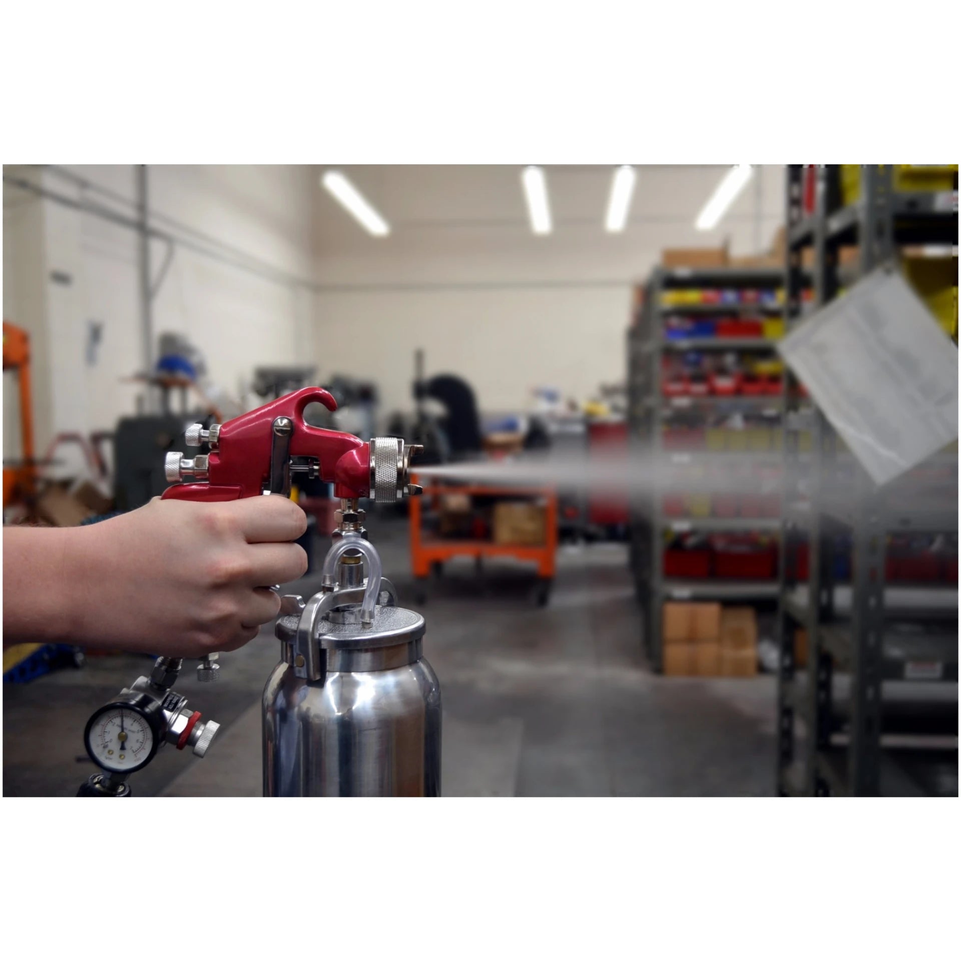 Astro Pneumatic 4008 Red Handle Spray Gun in use, spraying in a workshop