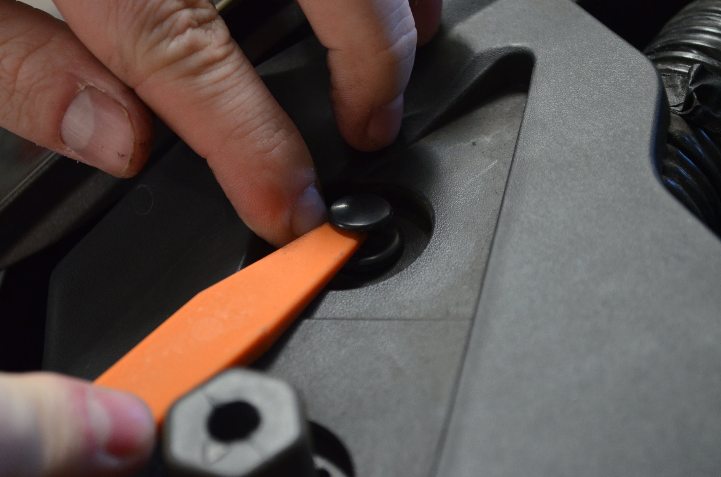 Astro Pneumatic 4524 orange plastic trim tool removing automotive interior fastener clip action shot