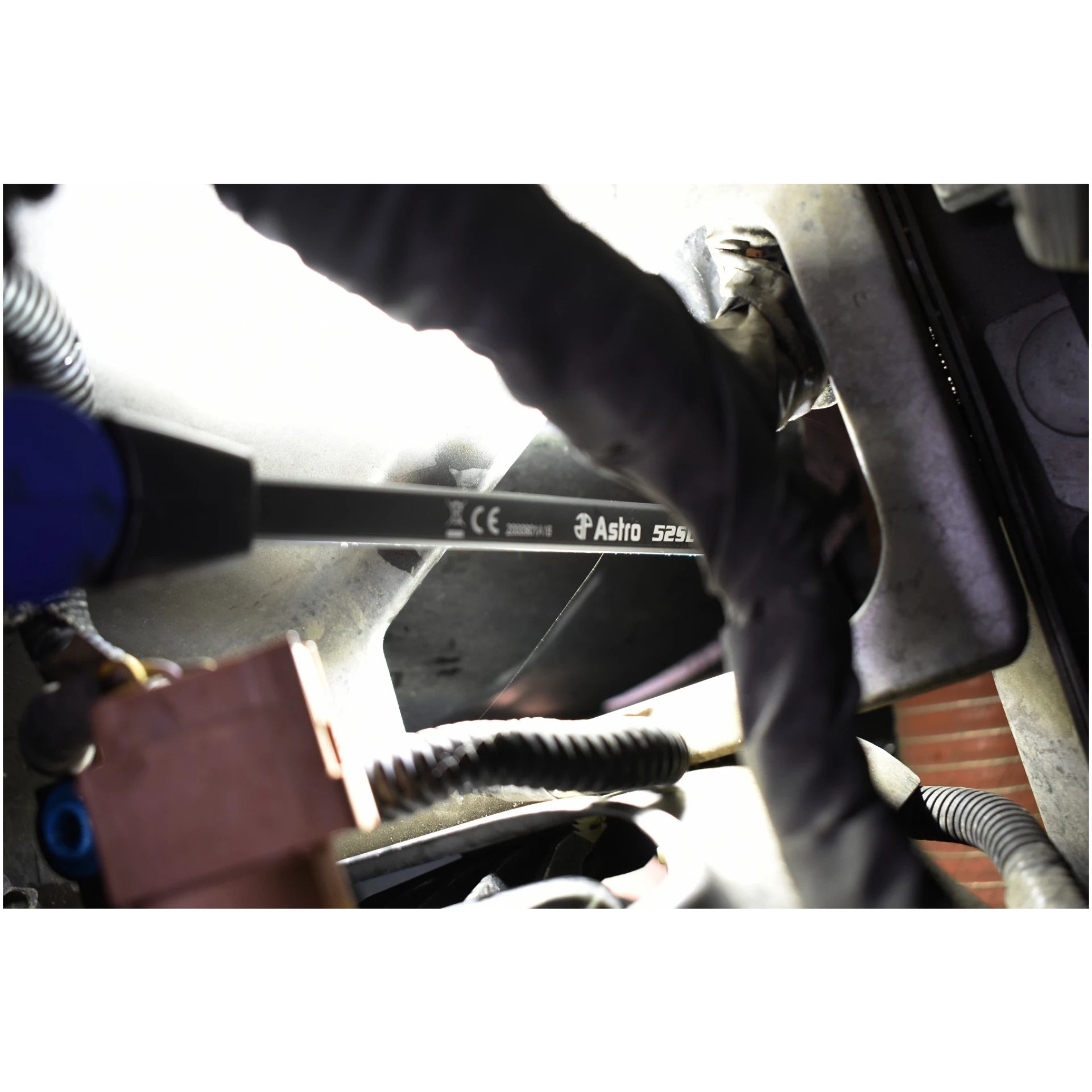 Astro Pneumatic 52SL LED Slim Light inserted into vehicle undercarriage showing Astro 52SL branding on light bar