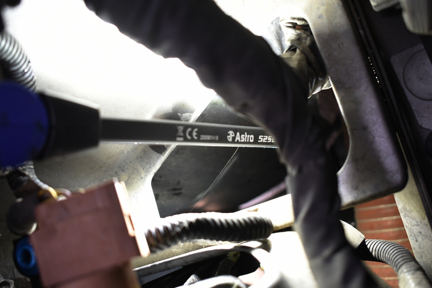 Astro Pneumatic 52SL LED Slim Light in use illuminating vehicle engine bay components from underneath