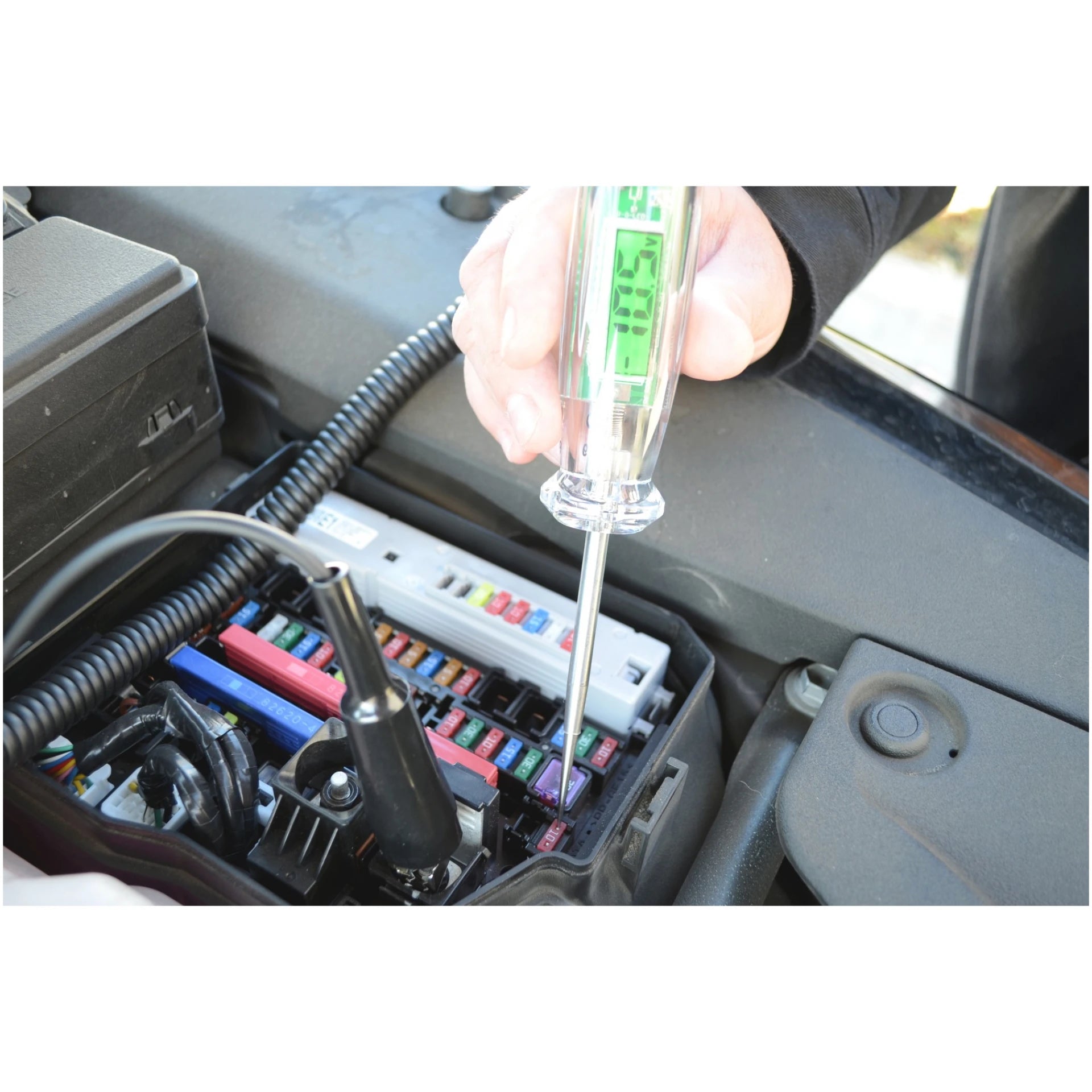 Astro Pneumatic 7767 Digital LCD Circuit Tester testing vehicle fuse panel with LCD reading