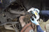 Mechanic using Astro Pneumatic AST-7868 ball joint adapter on vehicle suspension