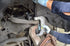 Mechanic using Astro Pneumatic 7897 ball joint C-frame press on vehicle suspension