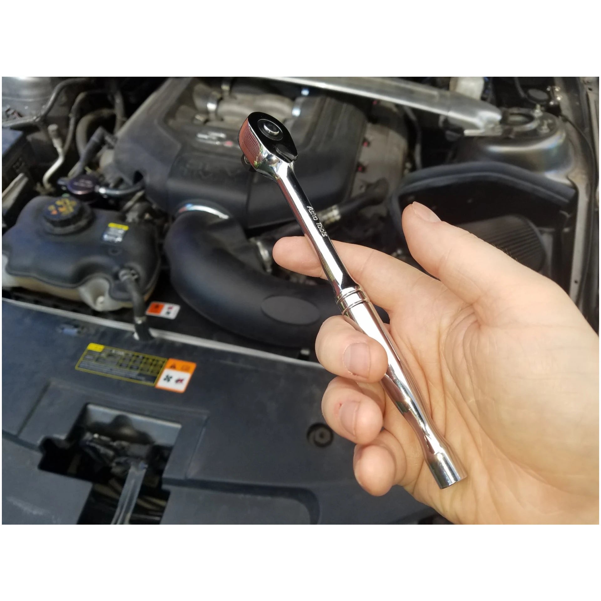 Astro Pneumatic 93808 Nano Ratchet held in hand near car engine bay