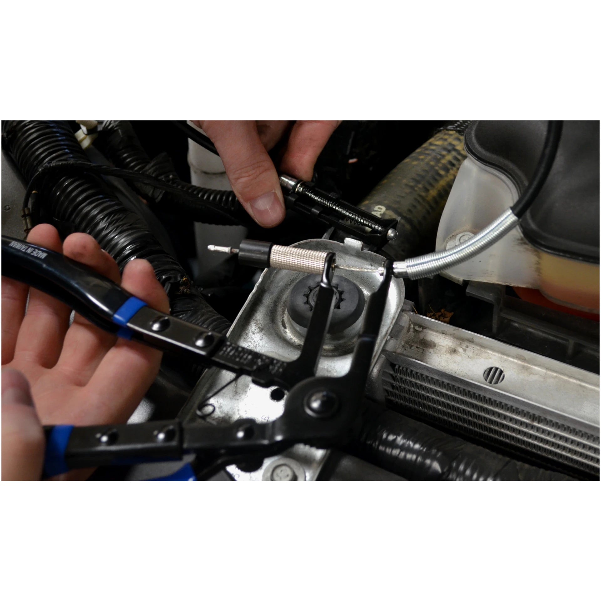 Astro Pneumatic 9409A Hose Clamp Pliers demonstrating extended cable reach in engine bay