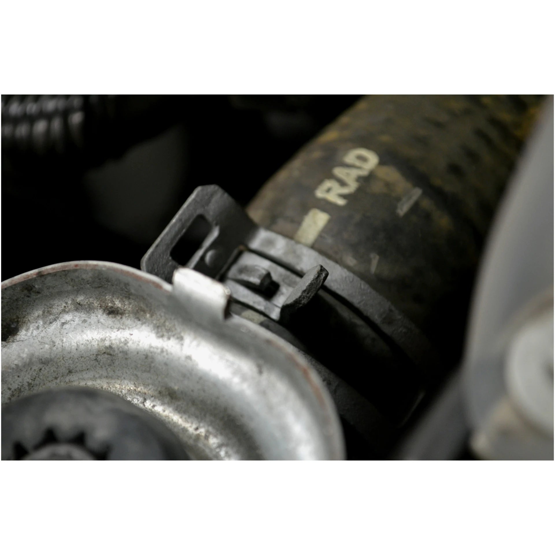 Close-up of self-tightening hose clamp on automotive radiator hose
