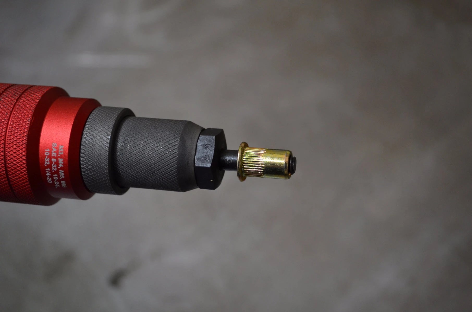 Astro Pneumatic ADN14 drill adapter with a rivet nut loaded onto the mandrel nosepiece