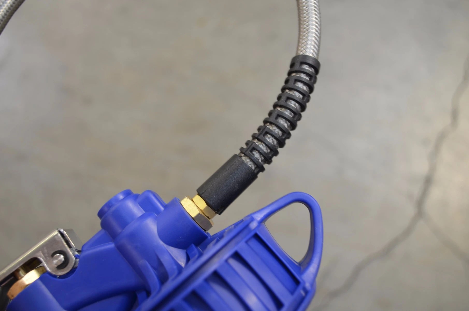 Astro Pneumatic AST-3018 tire inflator stainless braided hose connector close-up view