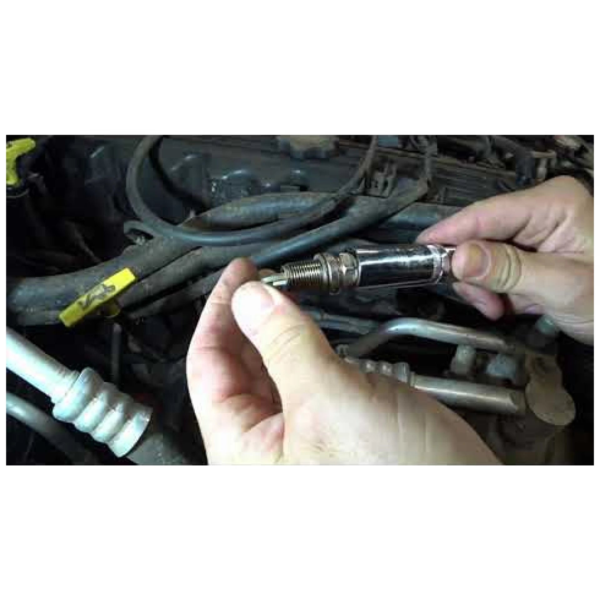 Astro Pneumatic 94404 spark plug socket lifestyle shot holding spark plug on engine