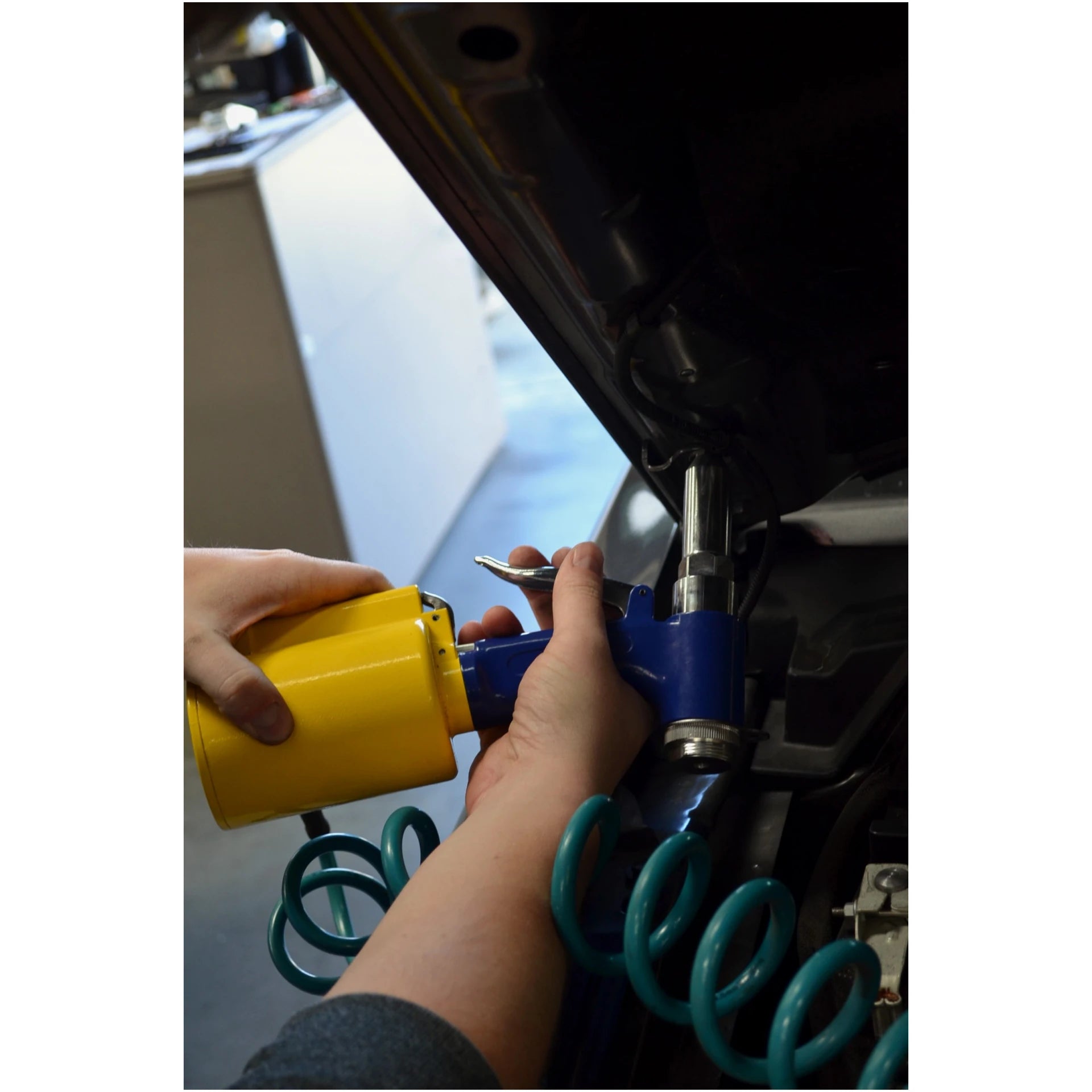 Astro Pneumatic PR36 Air Riveter being operated under vehicle hood at angle